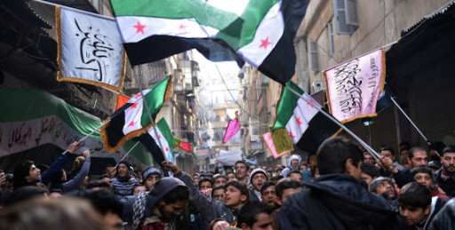 Secular demonstrators, shown at a protest march this month in Aleppo, wave the old Syrian flag (green, white, black and red) that has become the symbol of their opposition movement.
